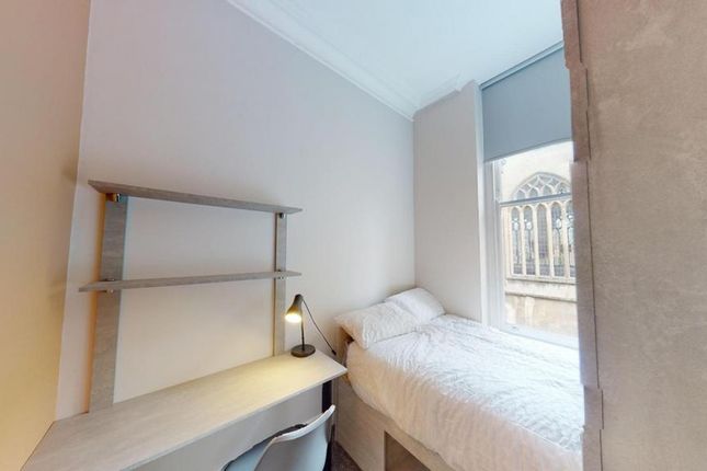 A Tidy And Well-Lit Single Bedroom Featuring A Com...