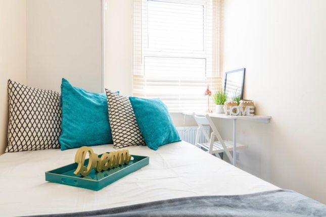 This Cozy Double Bedroom Features Vibrant Teal Cus...