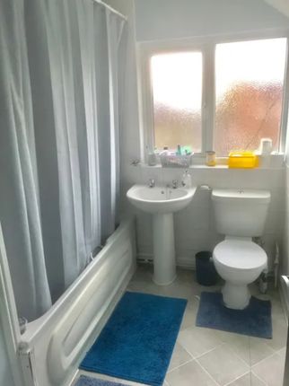 A Bright And Tidy Bathroom Featuring Modern Fixtur...