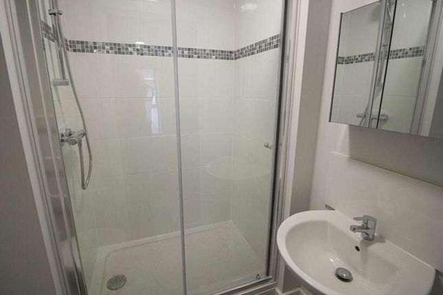 A Modern Bathroom Featuring A Stylish Glass Shower...