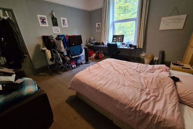 A Cozy Master Bedroom Featuring A Comfortable Doub...