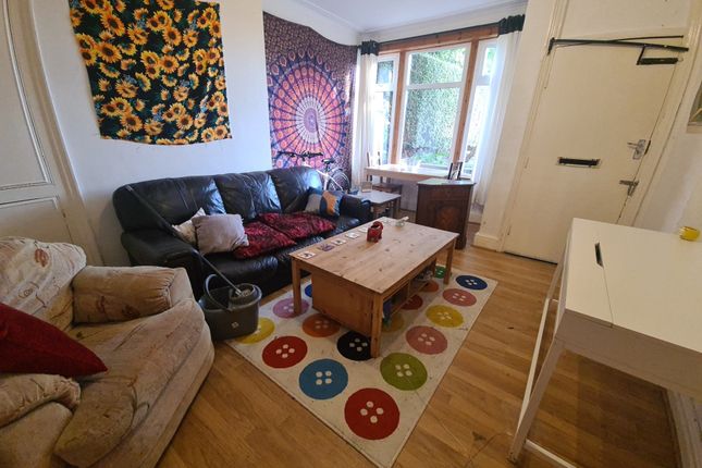 A Cozy And Well-Lit Living Room Featuring A Comfor...