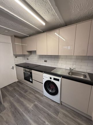This Modern Kitchen Features Sleek Cabinetry And A...