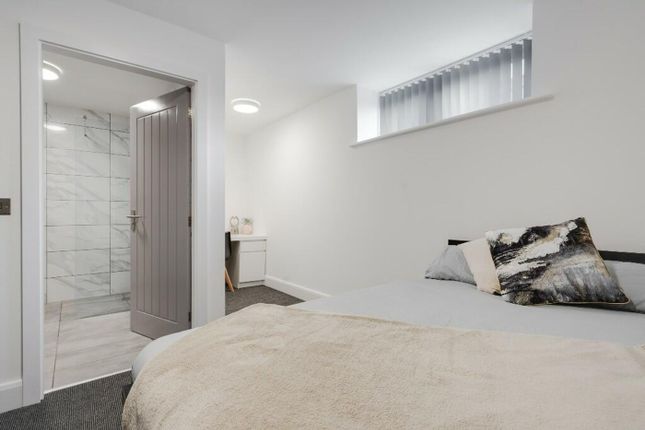 A Stylish Double Bedroom Featuring Modern Decor, A...