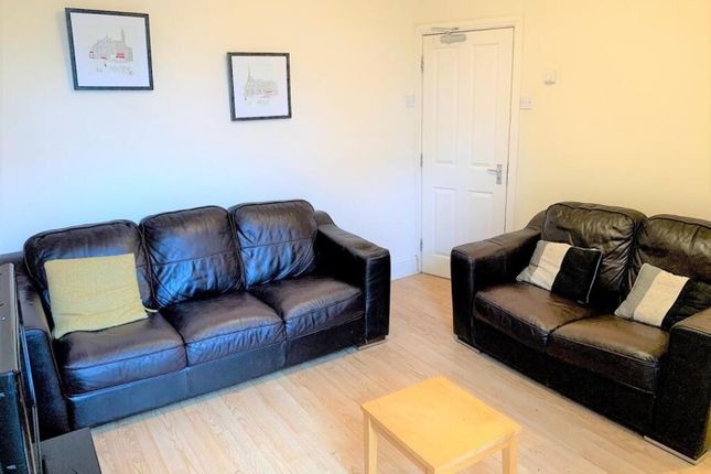 A Cozy And Inviting Living Room Featuring Comforta...