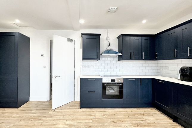 This Modern Kitchen Features Sleek Navy Cabinetry,...