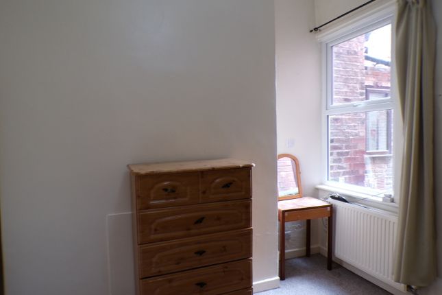 A Cozy Double Bedroom Featuring A Classic Dresser ...