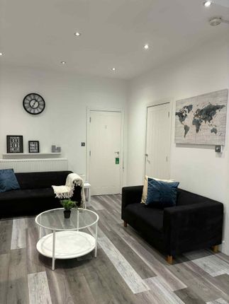 A Modern, Well-Lit Living Room Featuring Two Black...