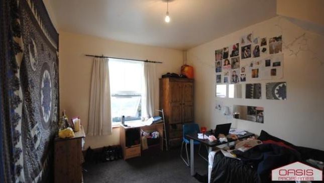 A Bright And Welcoming Living Room With A Large Wi...