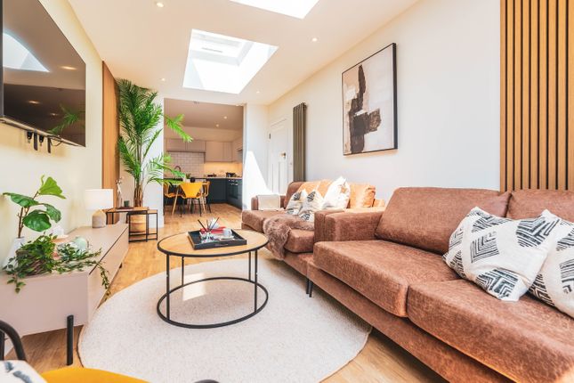 A Spacious And Stylish Modern Living Room Featurin...