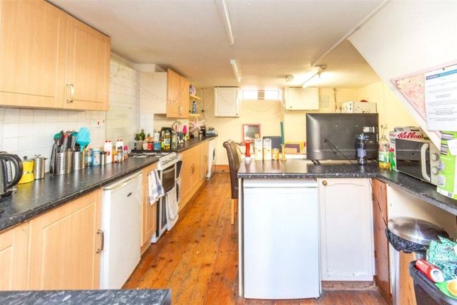 A Bright And Well-Equipped Kitchen With Ample Coun...