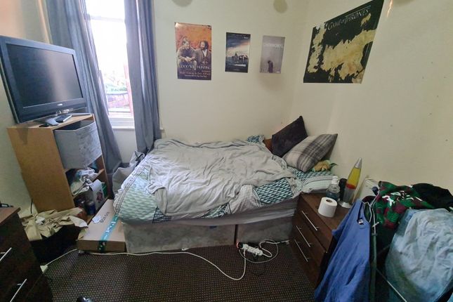 Cozy Bedroom Featuring A Neatly Made Bed With Soft...