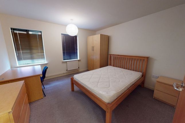 Bright And Inviting Master Bedroom With A Wooden d...