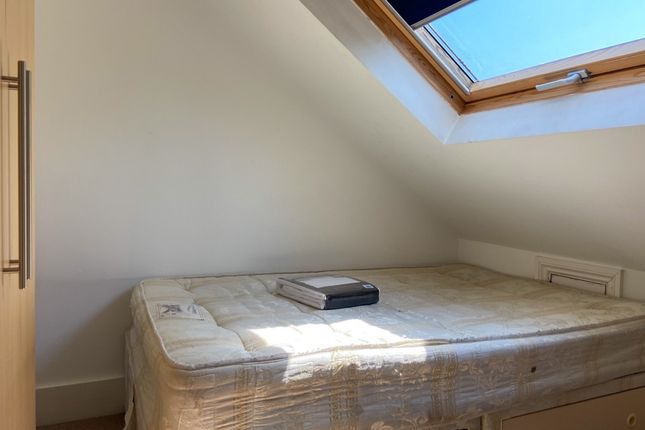 Bright Bedroom Featuring A Large Skylight Allowing...