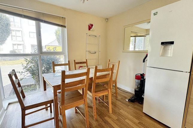 A Bright, Tidy Living Room Featuring Large Windows...