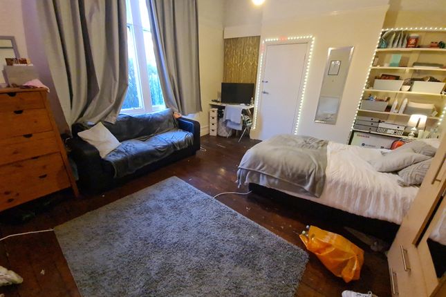 A Spacious And Inviting Bedroom Featuring A Comfor...