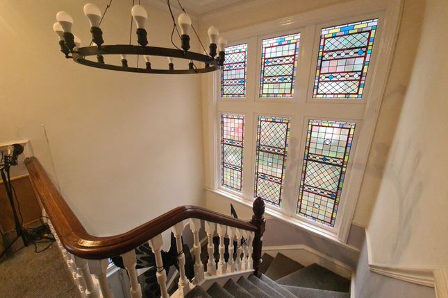 A Charming Staircase Featuring Elegant Wooden Bann...