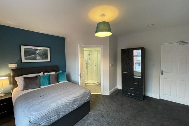 A Stylish And Spacious Master Bedroom Featuring A ...