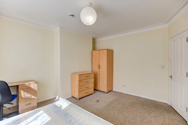 A Bright And Simple Bedroom Featuring A Wardrobe A...