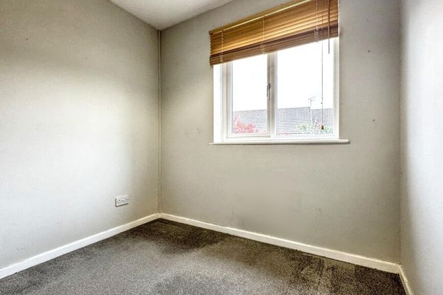 A Small, Neutral-Colored Room With A Single Window...