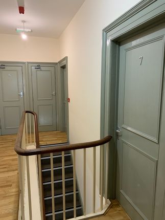A Clean And Well-Maintained Hallway With Light Woo...