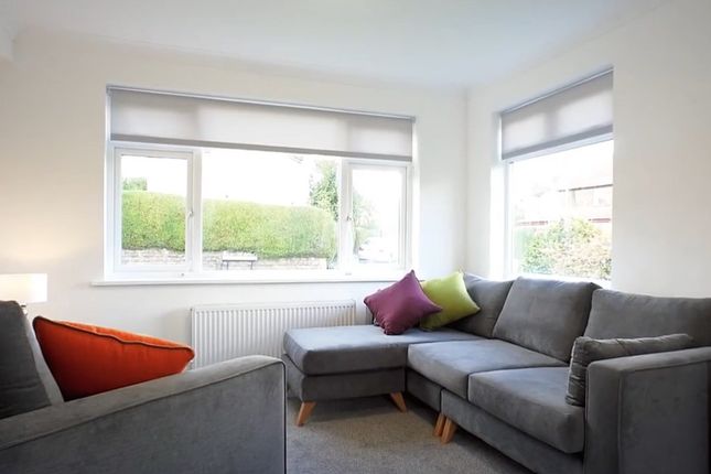 A Bright And Inviting Living Room Featuring A Comf...