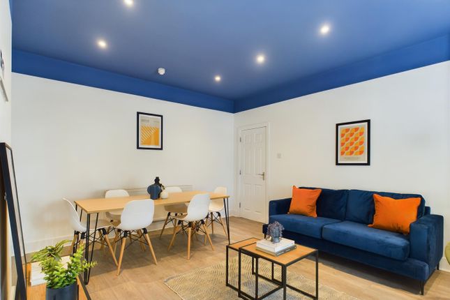 A Spacious And Stylish Living Room Perfect For Soc...
