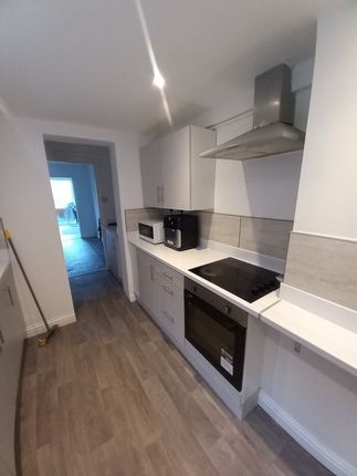 A Modern And Clean Galley Kitchen Featuring Sleek ...