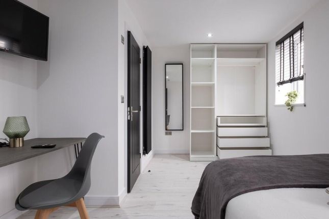 Bright And Modern Master Bedroom Featuring A Comfo...