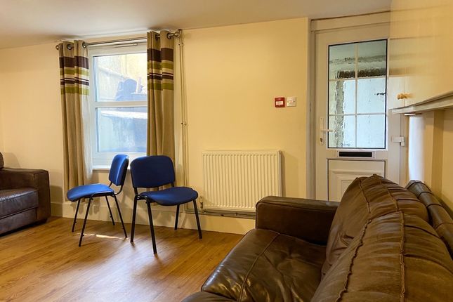 A Welcoming And Well-Lit Living Room With Comforta...