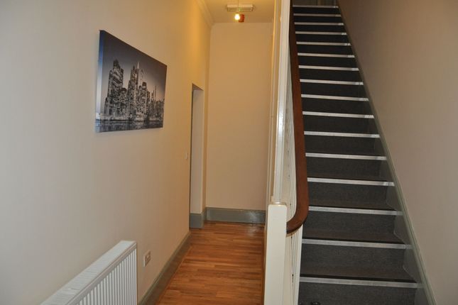 A Clean And Tidy Hallway Featuring Wooden Flooring...