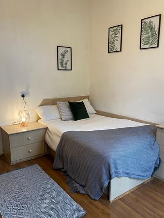 This Cozy Double Bedroom Features A Comfortable Be...
