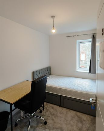 A Tidy And Simple Single Bedroom Featuring A Comfo...