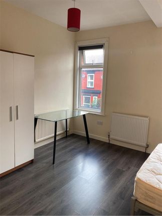 Bright And Tidy Bedroom Featuring A Large Window T...