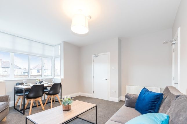 A Bright And Inviting Contemporary Living Room Fea...