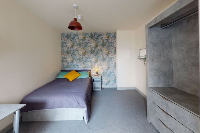 A Bright And Welcoming Bedroom Featuring A Cozy Be...