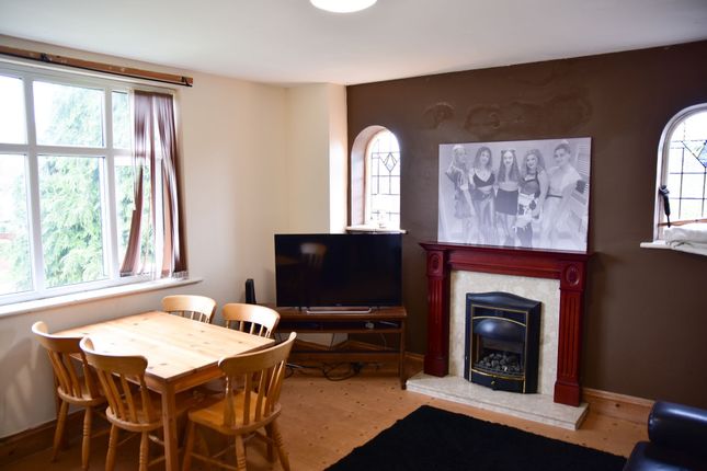 A Cozy Living Room Featuring A Wooden Dining Table...
