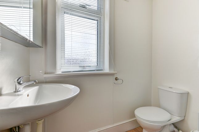 A Clean And Bright Bathroom With A Large Window An...