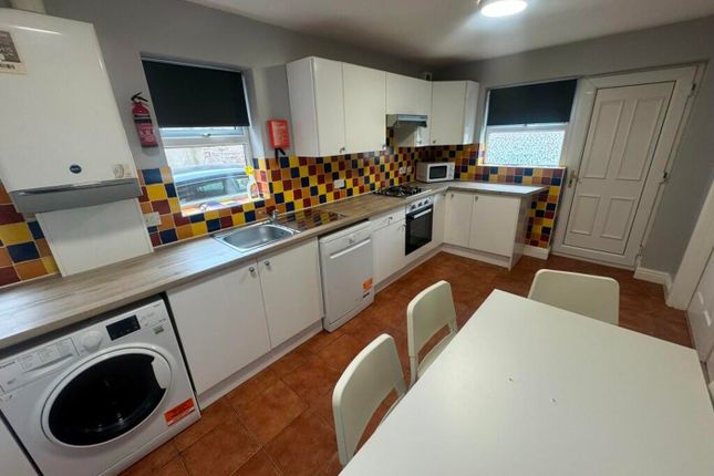 Spacious And Modern Kitchen Featuring Colorful Til...