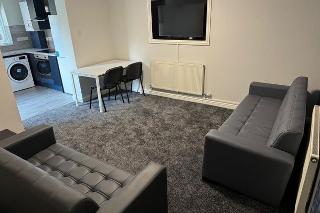 A Stylish And Inviting Living Room Featuring Comfo...