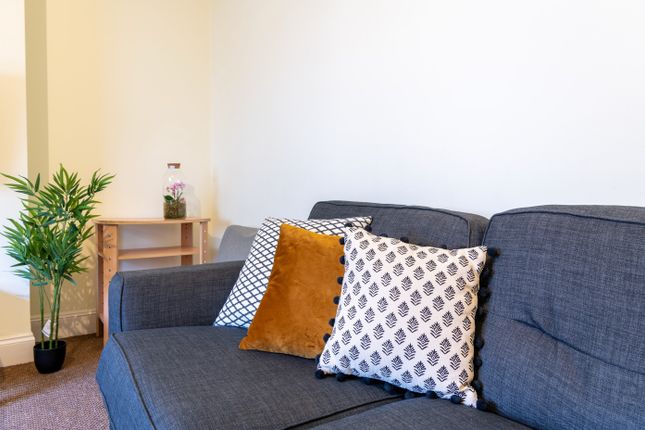 A Cozy And Inviting Living Room Featuring A Comfor...