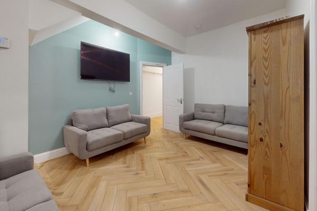 A Spacious And Stylish Living Room Featuring Moder...