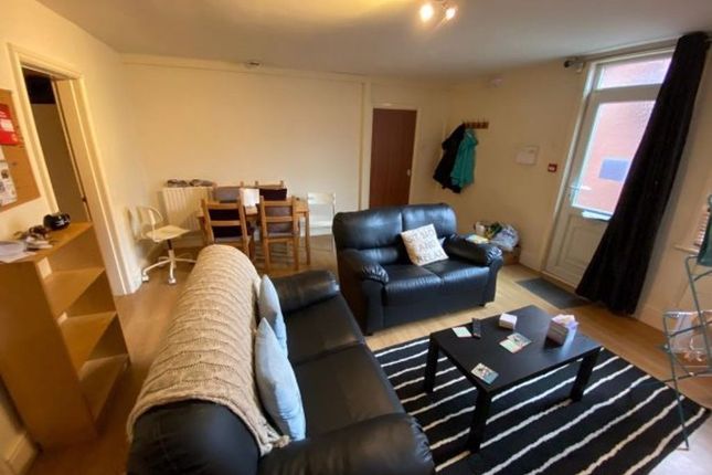 A Cozy And Inviting Living Room Featuring Comforta...