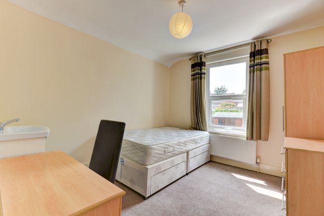 A Well-Lit Double Bedroom Featuring Two Beds, Offe...