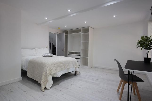 A Spacious And Modern Master Bedroom Featuring Bri...