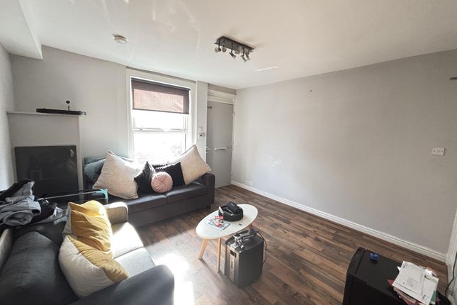 A Bright And Welcoming Living Room Featuring A Com...