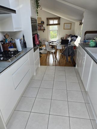 Bright And Modern Kitchen With Sleek White Cabinet...