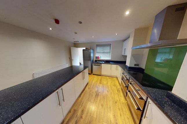A Spacious And Modern Kitchen Featuring Ample Coun...