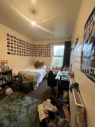 A Cozy, Well-Used Bedroom With Ample Space For A d...