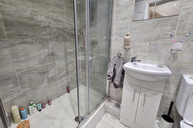 A Modern Bathroom Featuring A Shower Enclosure, A ...